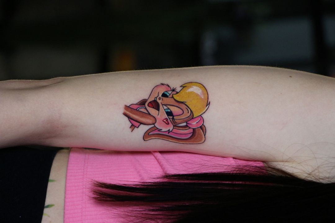 Color cartoon rabbit tattoo on upper arm