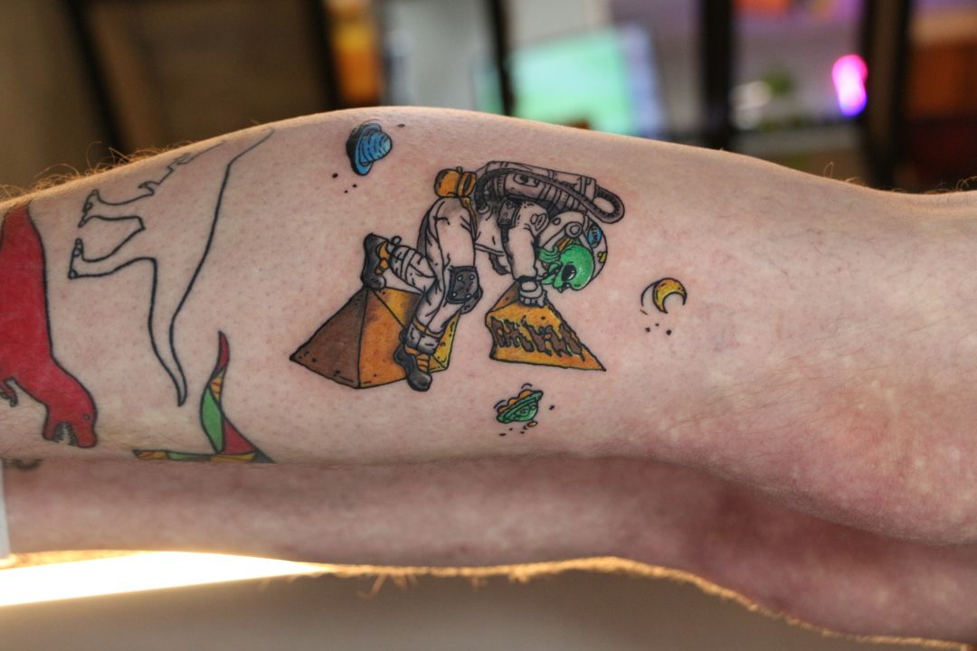 Color astronaut tattoo on leg