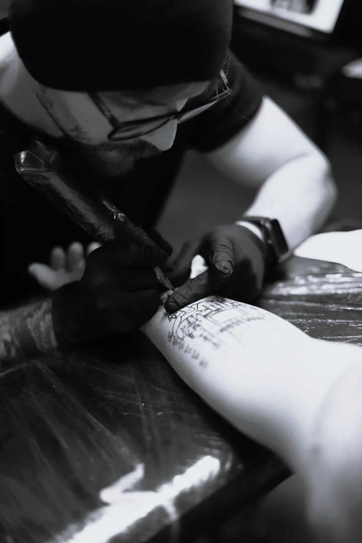 Tattoo artist Nikolay Ginzburg working on a custom tattoo